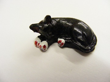 BLACK CURLED UP CAT